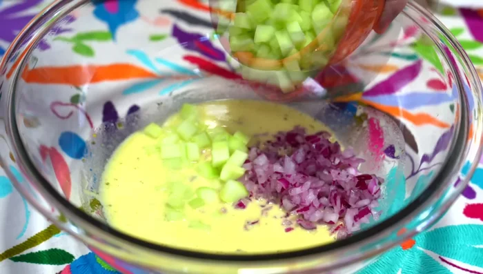 Combine chopped onion, cucumber, tomato, jalapeño slices, cilantro, radishes, and lettuce in a bowl. Mix.