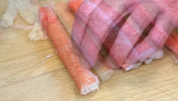 Cut the shredded surimi into smaller pieces.