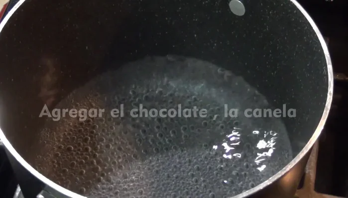 Add the chocolate bars, ground cinnamon, and the toasted cinnamon stick to the boiling water. Stir until the chocolate is melted and the cinnamon flavor is released.