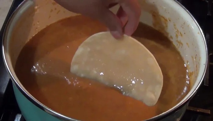 Layer the tortillas with the bean and chorizo mixture.