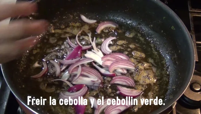 Add more oil to the pan and sauté the red and green onions.