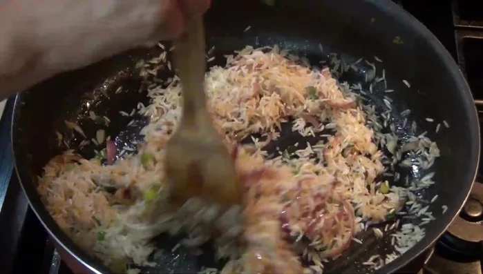 Add the rice, garlic, celery, and carrots to the pan.
