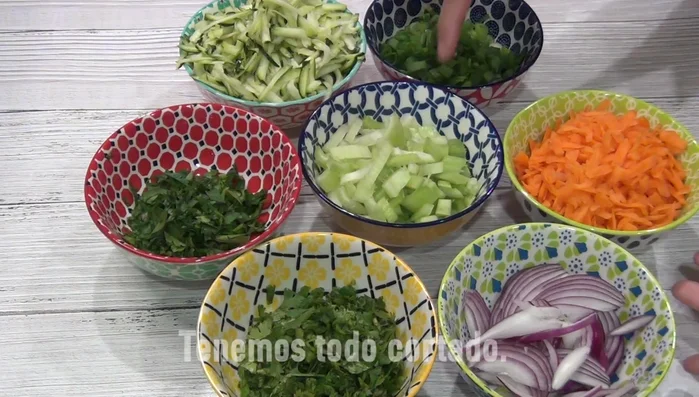 Chop the cilantro, parsley, onions, celery, and green onions.