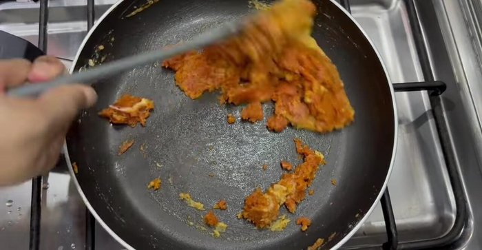 Stir in tomato paste and 2 glasses of water (adjust consistency). Whisk to remove lumps. Add cheese and mix until melted.