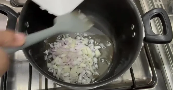 Sauté chopped onion in oil for 2-3 minutes until translucent. Add chopped garlic (or paste) and sauté for another 2-3 minutes.